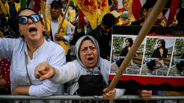 Iran president defiant as eight reported dead in protests over woman death