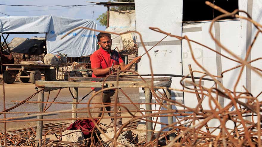 Desperate Gazans pull iron bars from rubble to construct tents and scratch out a living