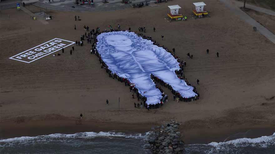 Giant portrait of girl killed in Gaza war unfurled on Barcelona beach
